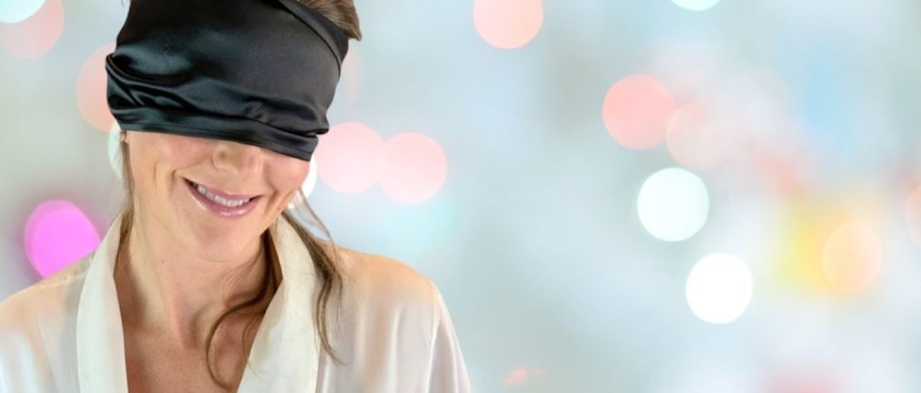 blindfold on Elisabet Barnes in white silk gown