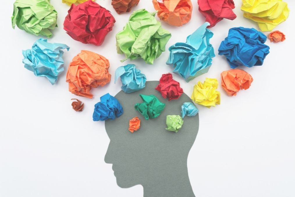 Head in profile with coloured paper balls, blog about couple arguments elisabet barnes